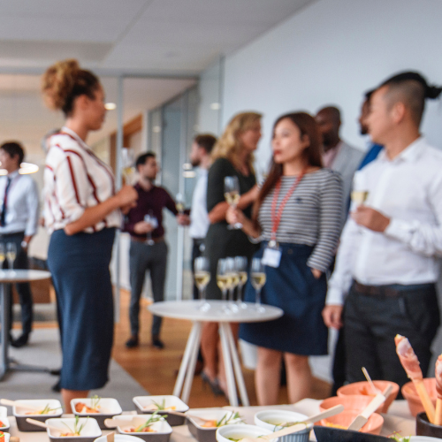 Colleagues at a work party socializing together 