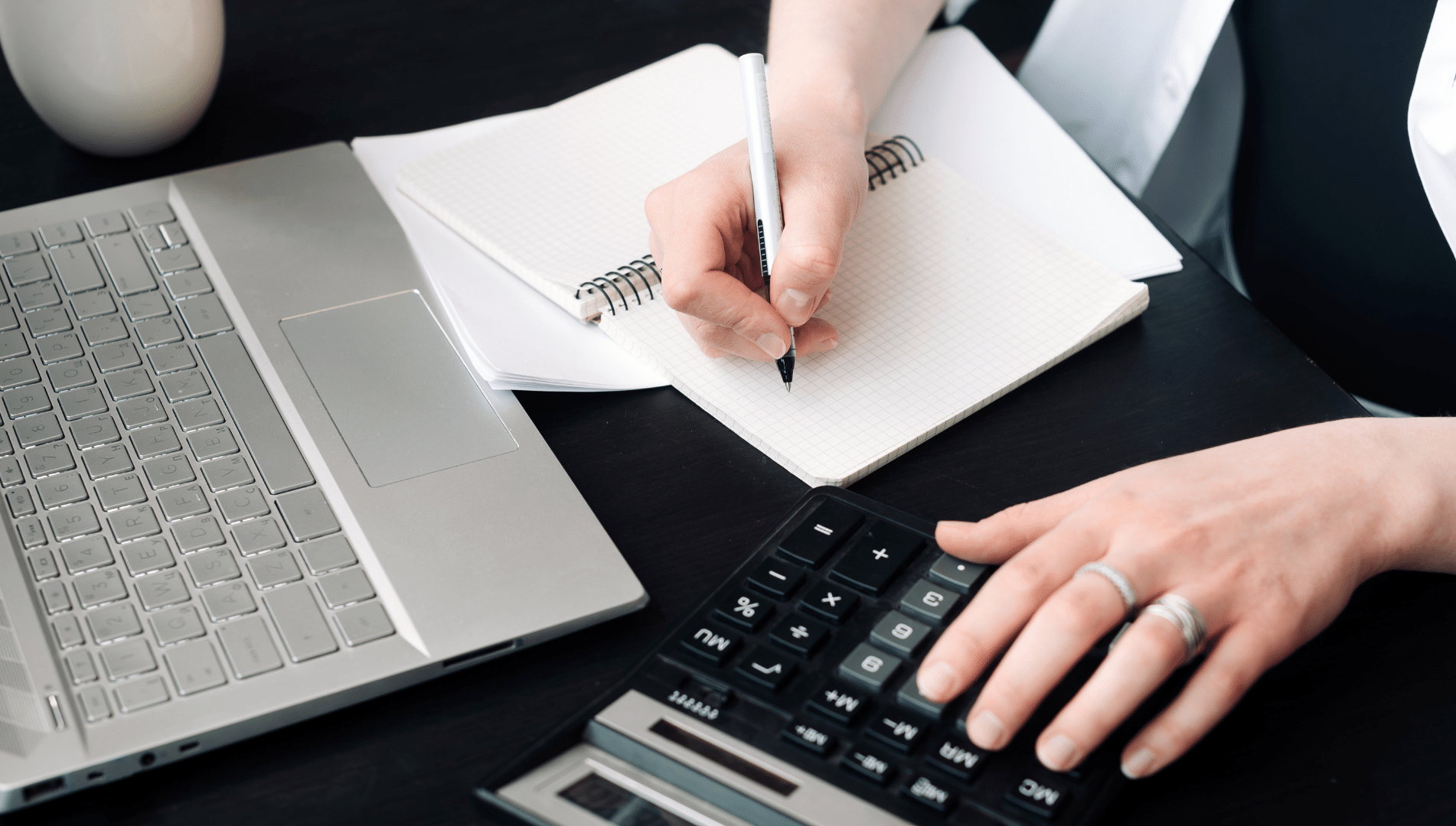 vector file of a person writing and using a calculator with a computer keyboard adjacent