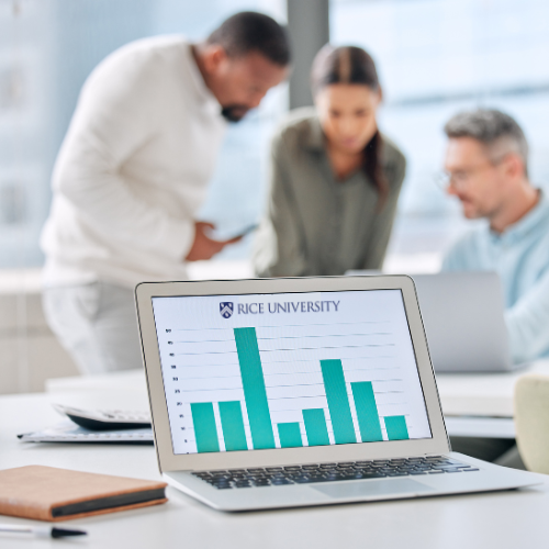 A bar graph displayed on a computer screen with team members huddled behind