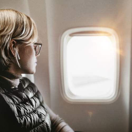 Woman looking out an airplane window
