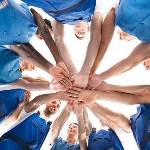 custodians huddled stacking hands 