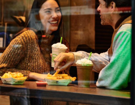 A couple enjoying a meal at Shake Shack