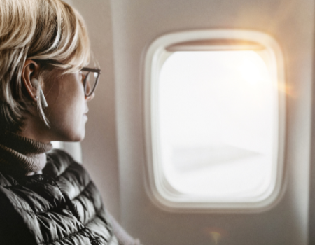 Woman looking out an airplane window
