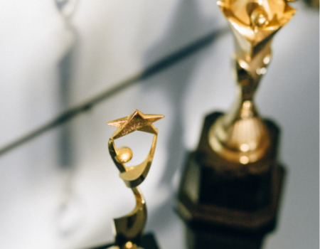 two gold award trophies