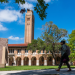 Student walking in front of a building on Rice's campus