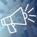 megaphone overlayed on a picture of wooden gears